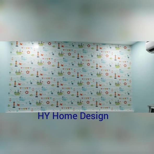 Wall mural installation in a children's room by HY Home Design